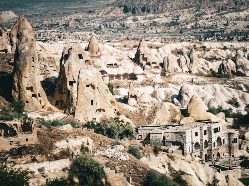 Explore the unique rock formations of Cappadocia in this stunning aerial view, showcasing ancient structures and eroded landscapes.