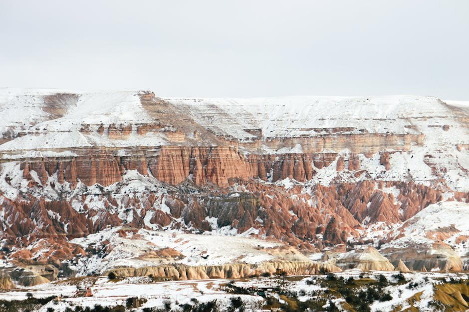 Breathtaking snow-covered rock formations in Cappadocia, Turkey during winter.